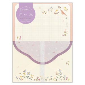 May include: A set of 8 letter writing sheets and 4 envelopes with a delicate floral design and a small bird. The paper is lined with a grid pattern and has a purple and white floral pattern on the back.