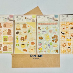 May include: Four sheets of brown and white patterned sticker paper with illustrations of bears, cakes, and other sweet treats. The sticker sheets are labeled "手帳デコ!" which translates to "Planner Decoration!" in English.
