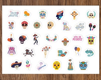 May include: A sheet of colorful Day of the Dead themed stickers. The stickers feature various images including skulls, flowers, a cat skeleton, a guitar, a bird, a chameleon, and the text "Dia de Muertos".