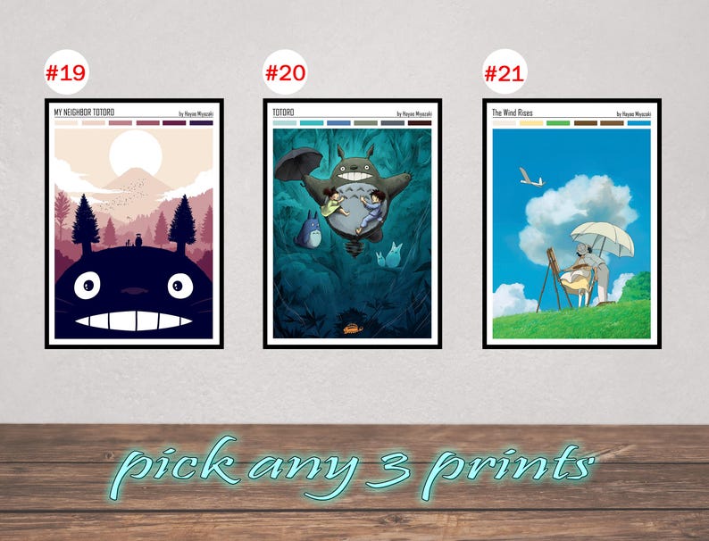 May include: Three framed art prints featuring characters and scenes from Studio Ghibli films. The prints include images from "My Neighbor Totoro" and "The Wind Rises". The text "pick any 3 prints" is written in a light blue script at the bottom.