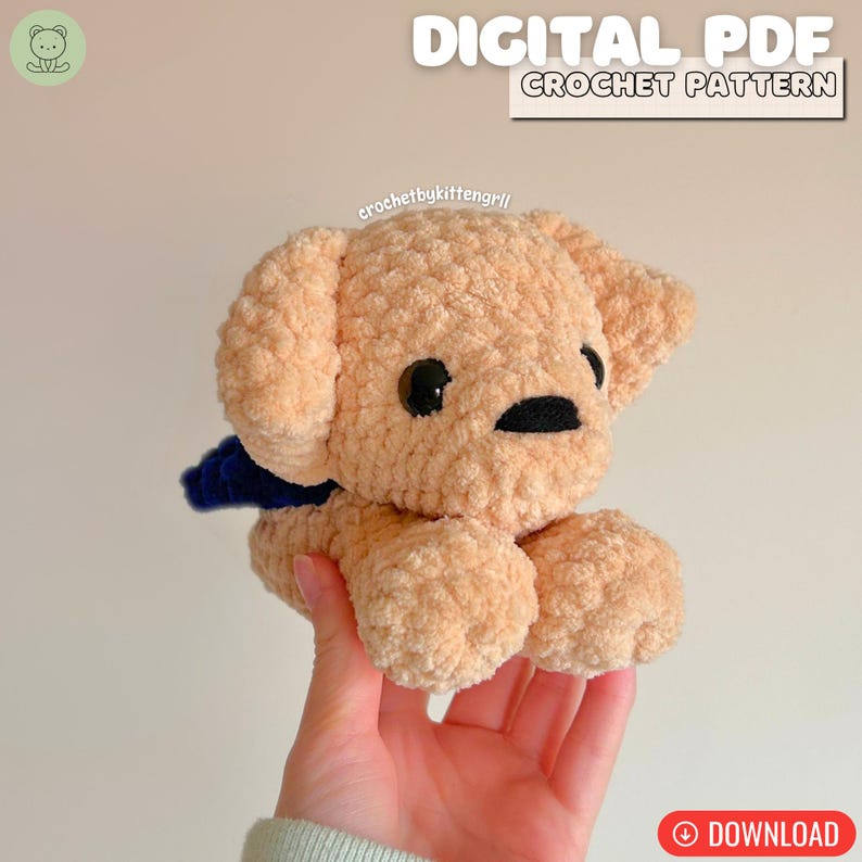 May include: A crocheted plush puppy in a light tan colour with black eyes and nose, and a dark blue scarf. The image includes the text "DIGITAL PDF CROCHET PATTERN" and the Etsy shop name "crochetbykittengrll".