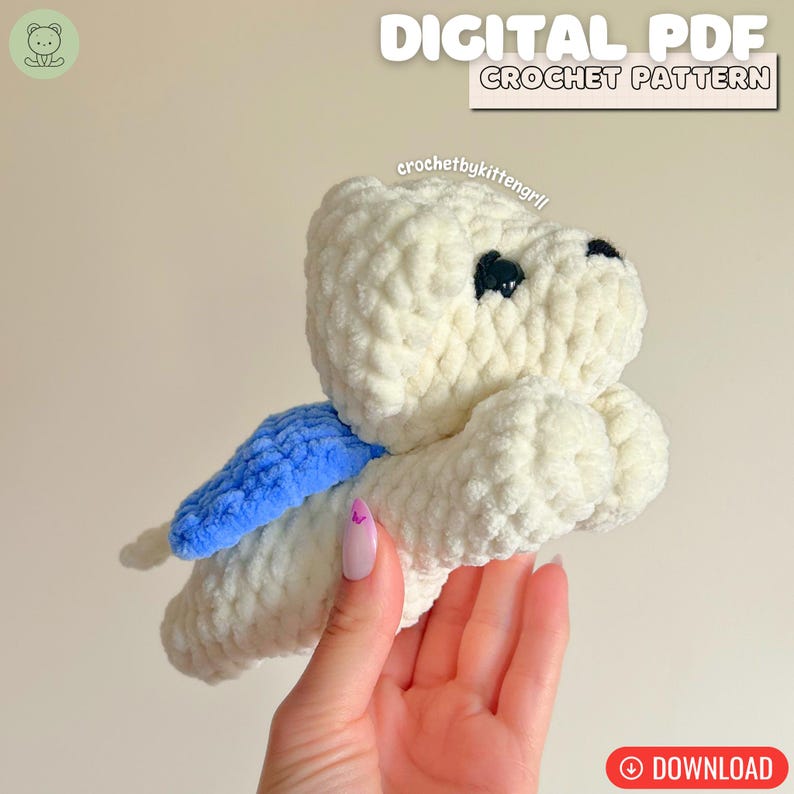 May include: A white crocheted toy with black eyes and a blue wing. The image includes the text "DIGITAL PDF CROCHET PATTERN" and the word "DOWNLOAD" in a red circle.