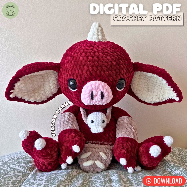 May include: Crochet pattern for a red and white plush toy with a pig nose and a horn. The toy is holding a smaller white plush toy. The pattern is called "Version 1 Arms".