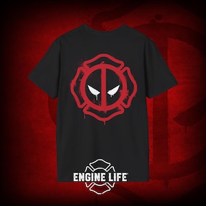 May include: Black t-shirt with a red and white fire department logo featuring a stylized Deadpool mask. The text "ENGINE LIFE" is printed below the logo.