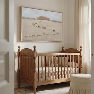 May include: A rectangular wall art print featuring a Noah's Ark scene with a wooden boat and various animals walking in a line across a sandy landscape, framed in a light-colored wood frame and displayed above a wooden crib with vertical slats.