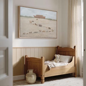 May include: A child's bedroom featuring a wooden bed with a teddy bear and a framed painting depicting animals walking towards a large ark. The room has a neutral color palette with beige walls and a patterned rug.