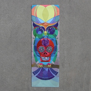 May include: A colorful geometric owl with a red skull and crossbones design. The owl is made up of various shapes and colors, including blue, green, purple, and yellow.