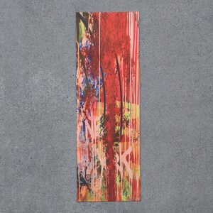 May include: Abstract art print with a vertical design featuring a mix of red, pink, blue, green, and yellow paint splatters and streaks.