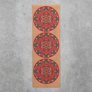 May include: A cork yoga mat with three repeating mandala designs in shades of red, orange, yellow, green, and blue.