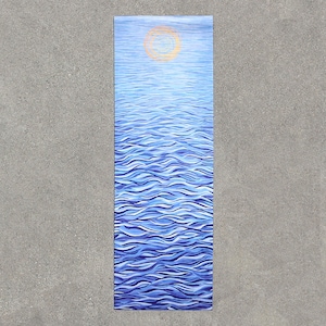 May include: A blue yoga mat with a white and gold mandala design. The mat features a wavy pattern that resembles water.