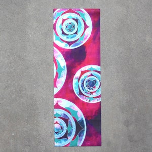 May include: A pink yoga mat with a repeating pattern of blue and white mandalas.