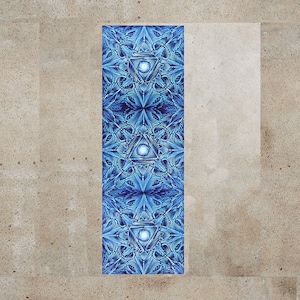 May include: A blue yoga mat with a geometric pattern featuring a repeating triangle design with a white circle in the center of each triangle.