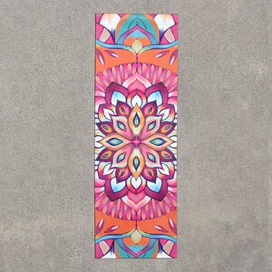 May include: A colorful yoga mat with a mandala design in shades of pink, orange, blue, and green.