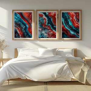 Puede incluir: Tres impresiones de arte abstracto enmarcadas con un patrón de ágata azul y rojo. Las impresiones están colgadas en una pared blanca sobre una cama blanca con una manta beige.