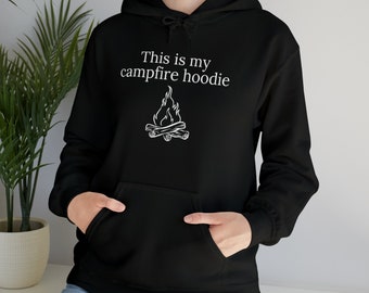 May include: Black hoodie with white text that reads "This is my campfire hoodie" and a white illustration of a campfire.