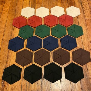Set of four matching solid color hexagon fabric coasters