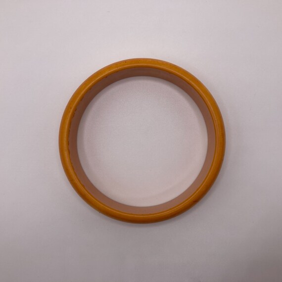 1940s Vintage Butterscotch, Black, and Red Floral Carved End of Day Bakelite Bangle main image 0
