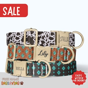 May include: Three personalized dog collars with gold-colored buckles. The collars feature unique patterns: a black and white cow print, a brown and turquoise geometric design, and a black and turquoise southwestern pattern. The collars are labeled with the names "Stella", "Lily", and "Bella".