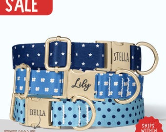 May include: Three dog collars with gold buckles, each personalized with a name. Patterns include navy blue with white stars, light blue with white floral designs, and light blue with navy blue polka dots. A red banner displays the word "SALE".