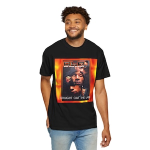 May include: Black t-shirt featuring a graphic design with the text "ELF GET LOW PLAYAZ" and "STRAIGHT OUT THE LABB". The design includes a portrait of two people with a fiery orange and yellow background.