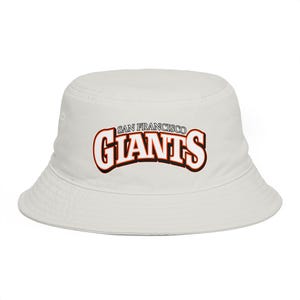 May include: White bucket hat with the text "SAN FRANCISCO GIANTS" in a bold, stylized font. The text is outlined in black and red, with a white interior. The hat is a classic, casual style.