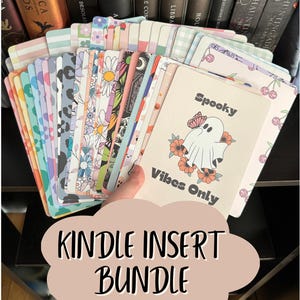 May include: A collection of rectangular cards featuring various patterns including floral, leopard print, plaid, and cherry designs. The front card displays a white ghost illustration with orange flowers, a butterfly, and the text Spooky Vibes Only.