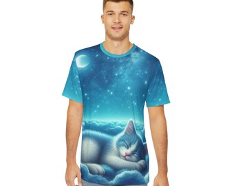Op de afbeelding: Een blauw T-shirt met een witte kat die slaapt op wolken in een sterrenhemel. De maan is zichtbaar in de linkerbovenhoek van het ontwerp.