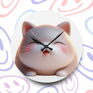 May include: A round wall clock featuring a smiling cartoon cat with pink cheeks and a happy expression. The clock has black hands and is set against a white background with a pattern of smiling faces.