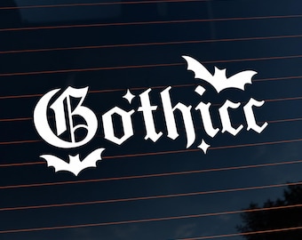 May include: A white vinyl decal featuring the word Gothicc written in a stylized gothic font. The design includes a small bat silhouette positioned above the letter i and another bat silhouette located below the letter G, with small star accents.