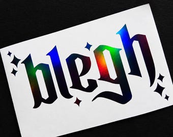 May include: A rectangular white sticker featuring the word blegh written in a black gothic-style font with a holographic rainbow effect. The design is accented by several small four-pointed star shapes surrounding the text on a white background.