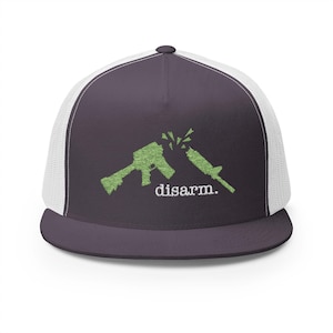 May include: A dark purple and white trucker hat with a green silhouette of a broken rifle and the text "disarm." embroidered on the front.