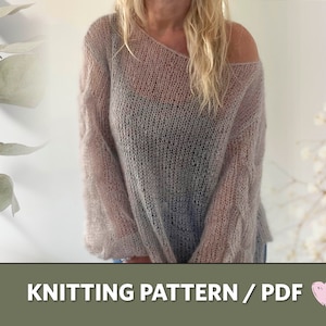 May include: Knitting pattern PDF for a loose-fitting, light grey sweater with a wide neckline and long sleeves. The sweater is made with a delicate, open stitch pattern.