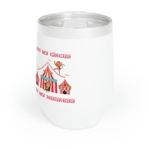 May include: White stainless steel wine tumbler with a red and white circus tent and monkeys graphic. The text on the tumbler reads "Not my circus, not my monkeys".