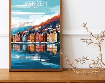 May include: A framed print of Bergen, Norway, with a colourful illustration of the city. The artwork shows a row of bright buildings reflected in the water, with the text "BERGEN NORWAY" at the top. The frame is a warm brown colour.