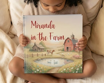 Könnte beinhalten: Ein Kind hält ein Buch mit dem Titel "Miranda in the Farm". Das Cover zeigt eine Aquarellillustration einer Bauernhofszene mit roter Scheune, Teich, Kuh und Sonnenuntergang. Der Titel ist in Schreibschrift gehalten.