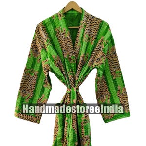 May include: A green and brown patterned robe with the text "Handmadestoreelndia". The robe features a tiger stripe design and is made of a soft, lightweight material. The robe is tied at the waist with a matching belt.