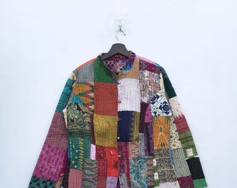 May include: A colorful patchwork jacket with a mandarin collar and button closure. The jacket is made of a variety of fabrics in different colors and patterns, including red, orange, yellow, green, blue, purple, and brown.