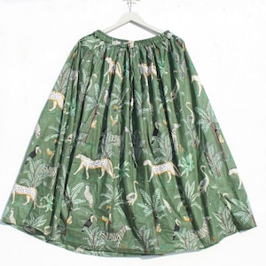 May include: A green maxi skirt with a jungle print featuring leopards, zebras, toucans, and palm trees.