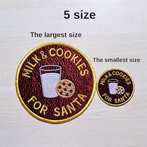May include: Two embroidered patches with a gold border. The larger patch reads "MILK & COOKIES FOR SANTA" around a glass of milk and a chocolate chip cookie. The smaller patch has the same design. The text "5 size" is above the patches.