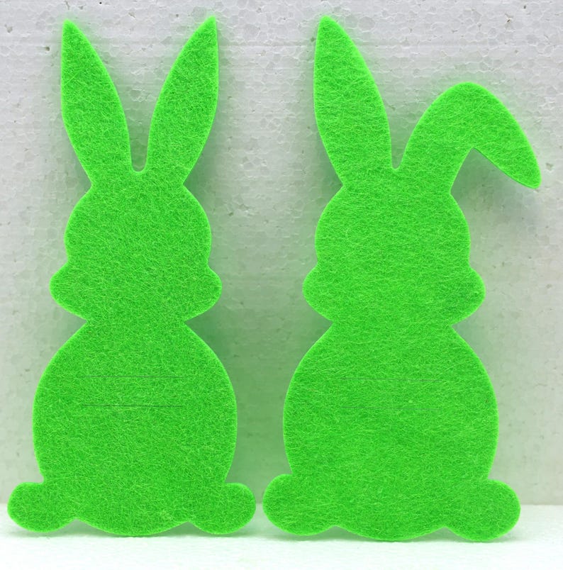 May include: Two green felt bunny shapes, perfect for crafting or decorating.