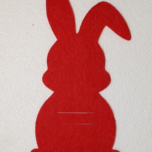 May include: Red felt bunny rabbit cutout with a blank space for writing or drawing. This is a craft supply for making Easter decorations.