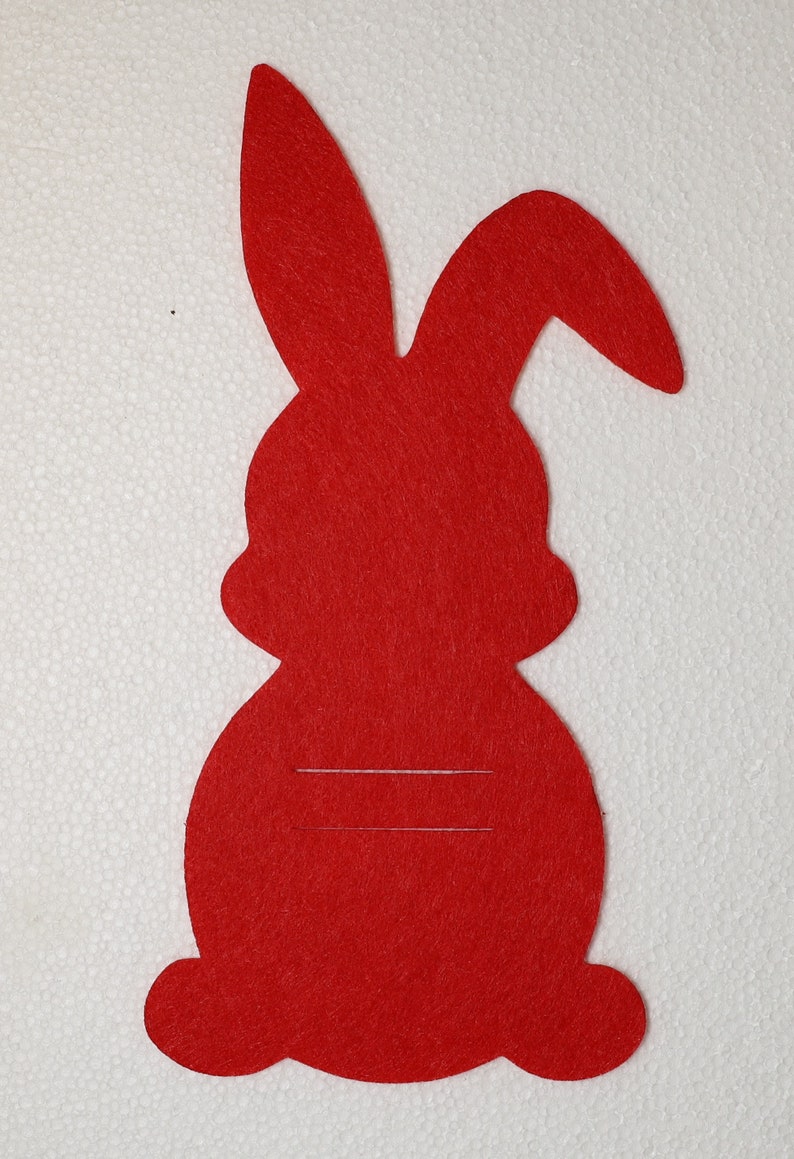 May include: Red felt bunny rabbit cutout with a blank space for writing or drawing. This is a craft supply for making Easter decorations.