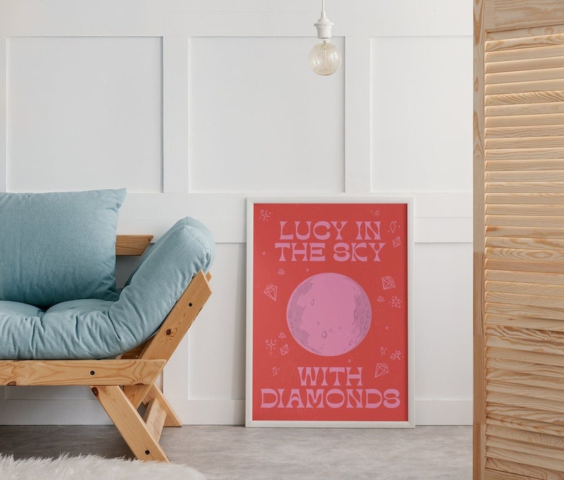 Lucy In The Sky With Diamonds Print Poster. Inspired by The Beatles famous song. Red and pink design with a moon in the middle and diamonds and stars around the writing and moon.