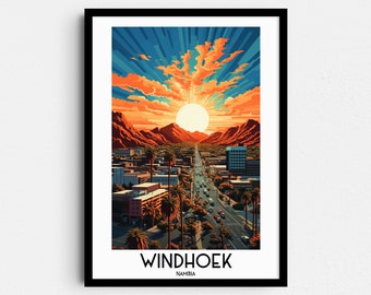 May include: A framed print of a city skyline with a sunset over the mountains. The city is Windhoek, Namibia. The print is in a black frame.