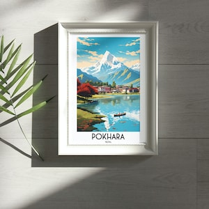 May include: A framed print of a colourful illustration of a mountain range, a lake, and a small village. The print is titled "POKHARA, NEPAL".