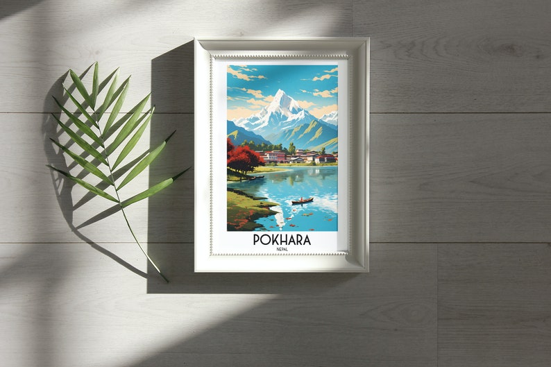 May include: A framed print of a colourful illustration of a mountain range, a lake, and a small village. The print is titled "POKHARA, NEPAL".