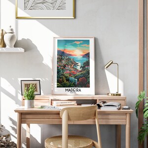 May include: A framed poster with a colorful illustration of a coastal town in Madeira, Portugal. The poster has the text "Madeira, Portugal" at the bottom.
