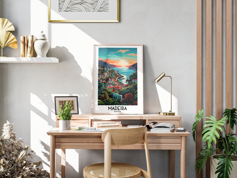 May include: A framed poster with a colorful illustration of a coastal town in Madeira, Portugal. The poster has the text "Madeira, Portugal" at the bottom.
