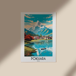 May include: A vintage travel poster depicting a scenic view of Pokhara, Nepal. The poster shows a mountain range with a lake in the foreground, surrounded by trees and a small village. The text "POKHARA, NEPAL" is printed at the bottom of the poster.