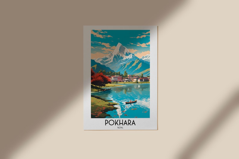 May include: A vintage travel poster depicting a scenic view of Pokhara, Nepal. The poster shows a mountain range with a lake in the foreground, surrounded by trees and a small village. The text "POKHARA, NEPAL" is printed at the bottom of the poster.